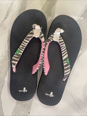 Sanuk Black Flip Flops with Zebra Striped Straps and Pink Accents